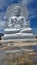 Reflection of White cloud and big white Buddha sculpture under blue sky