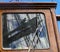 Reflection in window of sailboat, working aloft