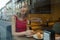 Reflection in the window, a young woman sitting in a cafe