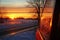 reflection of a winter sunrise on frosty car windows