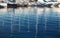 Reflection from yacht masts on the water in the port