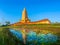 Reflection of yellow the high yellow pagoda in lotus pond