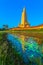 reflection of yellow the high yellow pagoda in lotus pond at wat Bang Tong