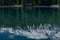 Reflections of a beautiful snow capped mountain in a blue mountain lake.