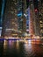 Reflections of a Cityscape: Captivating Night View of Skyscrapers Mirrored in Serene Waters