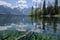 reflections of clear lake on windy day, with trees and mountains in the background