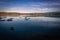 Reflections of clouds with fishing boats docked. San Vicente de la Barquera, Cantabria, Spain.