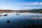 Reflections of clouds with fishing boats docked. San Vicente de la Barquera, Cantabria, Spain.