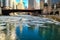 Reflections of colorful Chicago cityscape on a frozen chicago river with ice chunks floating under a bridge