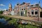 Reflections of colorful house facades along Kleine Dijlakker street in Bolsward, Friesland, Netherlands