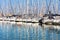 Reflections of colourful sailing boat masts on water