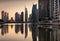 Reflections of Jumeirah Lakes Towers at dusk, Dubai, United Arab