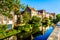 Reflections of medieval houses houses in the waters of a canal in Bruges, Belgium