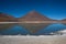 Reflections of mountains in the clear water of the Green Lake Laguna Verde on the Bolivian altiplano