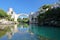 Reflections of the Old Bridge Stari Most, viewed from the banks of the Neretva river