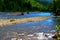 Reflections of the Sky Surround a White Water Rock Bed