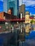 Reflections in the splash pad puddle water of Chicago cityscape. Commuters and tourists walk along the riverwalk in summer.