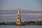 Reflections of the sunset on the bell tower in Kalyazin