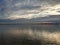 Reflections of sunset with cloudscape in lake water.