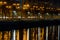 Reflections of trees and public lamps over Dambovita River. Horizontal view of glowing reflections of trees and public lamps over