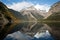 Reflective Lake Under Giant Mountains