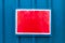 Reflective red notice board mounted on metal background