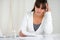 Reflective young woman working with documents