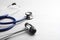 Reflex hammer with stethoscope on light wooden background, closeup. Nervous system diagnostic