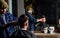Reflexion of barber with clipper trimming hair of client. Hipster client getting haircut. Barber with hair clipper works