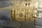 Reflexion of the catholic church in puddle in Porto