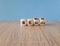 Refocus and rebrand symbol. Turned cubes and changed the word refocus to rebrand. Beautiful wooden table, blue background.