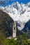 The reformed church tower and the mountain range Sciora in the mountain village Soglio
