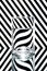 refraction of light by a glass on a black and white striped background. Abstract glass art