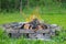 Refractory brick campfire in focus and blurred bonfire green grass in the background