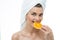 Refreshed woman eating orange