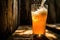 Refreshing beer pour into glass with splash on wooden background