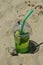 Refreshing cocktail with straw, mint and lemon on a sandy beach. summer vacation. delicious drink. background for the design.