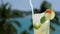 Refreshing coctail with lime and ginger on the sea background