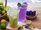 Refreshing drink with lemon lime and water lilac purple, decorated with lemon slice and purple pea flowers. Fresh lemon in the bo