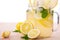 Refreshing drinks with ripe, juicy and fresh lemons, bright green mint and mineral water, isolated on a white background.