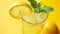 A refreshing glass of lemonade garnished with a slice of lemon and sprigs of fresh mint