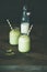 Refreshing iced coconut matcha latte drink in jars, copy space