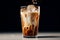 Refreshing and invigorating cold iced coffee on a dark background in a transparent glass
