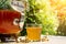 Refreshing kombucha tea with a medical camomile in old vintage bottle and glass, with label written kombucha on it on backdrop of