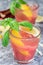 Refreshing lemonade with rhubarb, lemon, sparkling water and basil in a glass, vertical, closeup