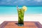 Refreshing mojito mocktail with straw on wooden table ocean background at the beach