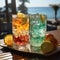 Refreshing multifruit juice drink on the background of the tropical nature. Glass of Refreshing cold lemon drink composition on a