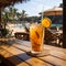 Refreshing orange juice drink on the background of the tropical nature. Glass of Refreshing cold lemon drink composition on a