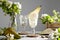 Refreshing Pear cocktail lemonade in a glasse with pear puree and fresh fruit and flowers on light gray table background