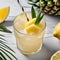 A refreshing pineapple coconut lemonade with a pineapple, coconut, and lemon garnish4